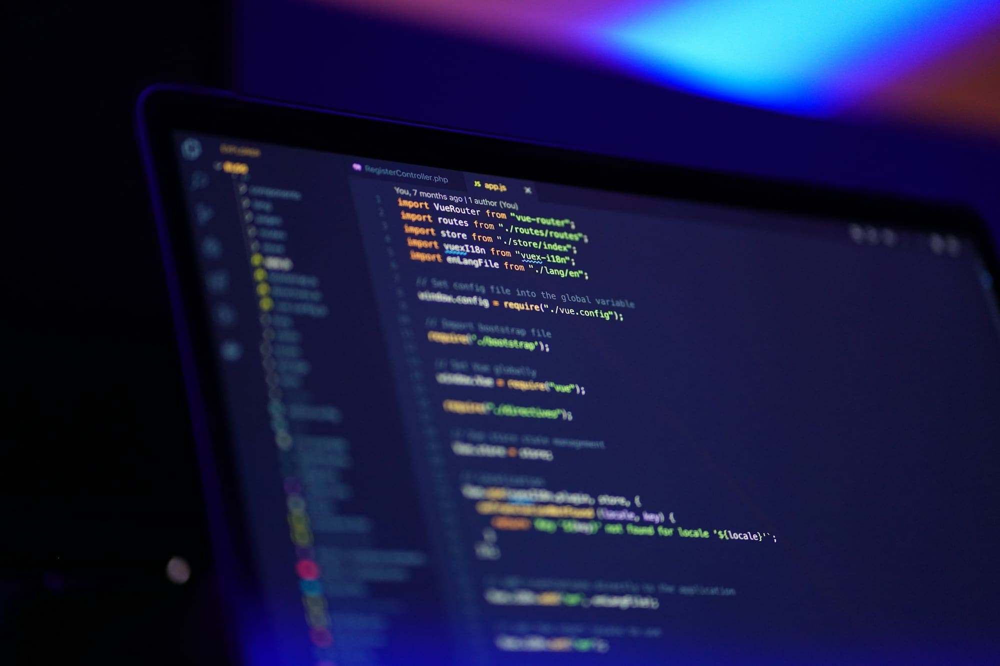 Laptop showing colourful code in an editor